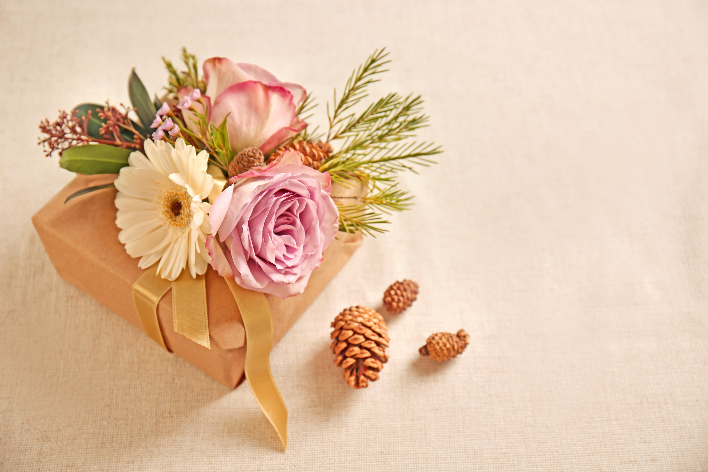 Gift Box with Flowers on Cream Background